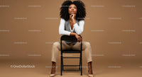 Stylish Confident Woman Sitting on Chair in Modern Studio