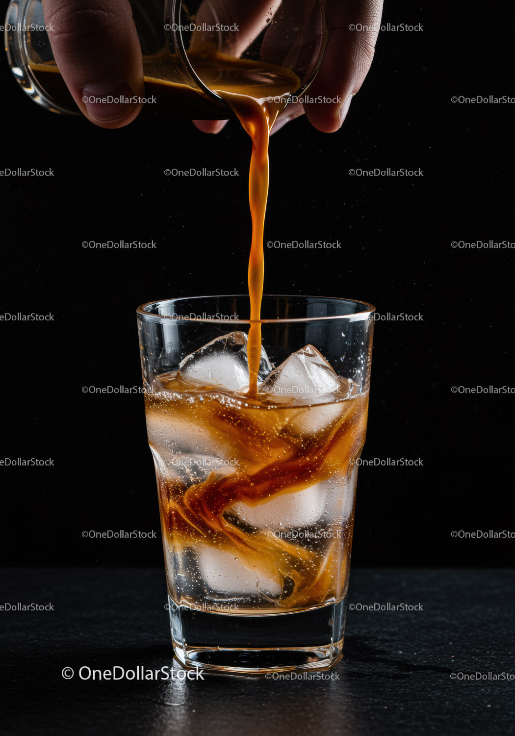 Cold glass of iced coffee with espresso shot pouring