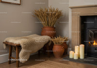 Cozy rustic corner with wool throw and dried wheat