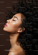 Serene profile of young woman with curly hair and makeup