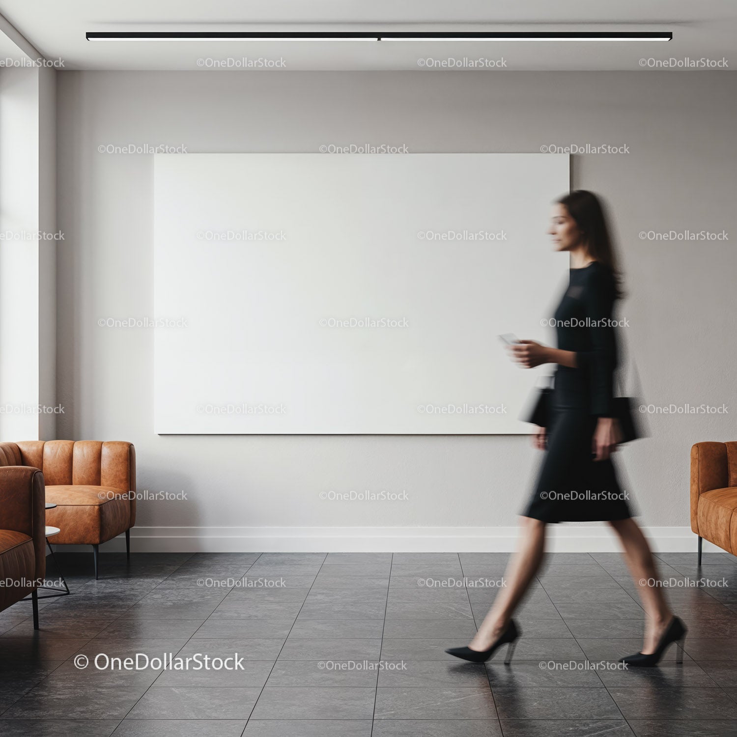 Blurred businesswoman walking past blank wall art