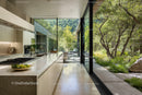 Modern Kitchen with Floor-to-Ceiling Glass Walls Overlooking Green Forest