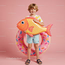 Smiling kid holding inflatable fish and donut float
