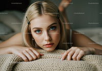 Stunning Young Woman with Blue Eyes Lying on Beige Blanket in Indoor Setting