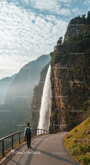 Scenic Mountain Waterfall with Hiking Trail and Lush Greenery