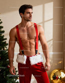 Fit man in festive red suspenders near Christmas tree