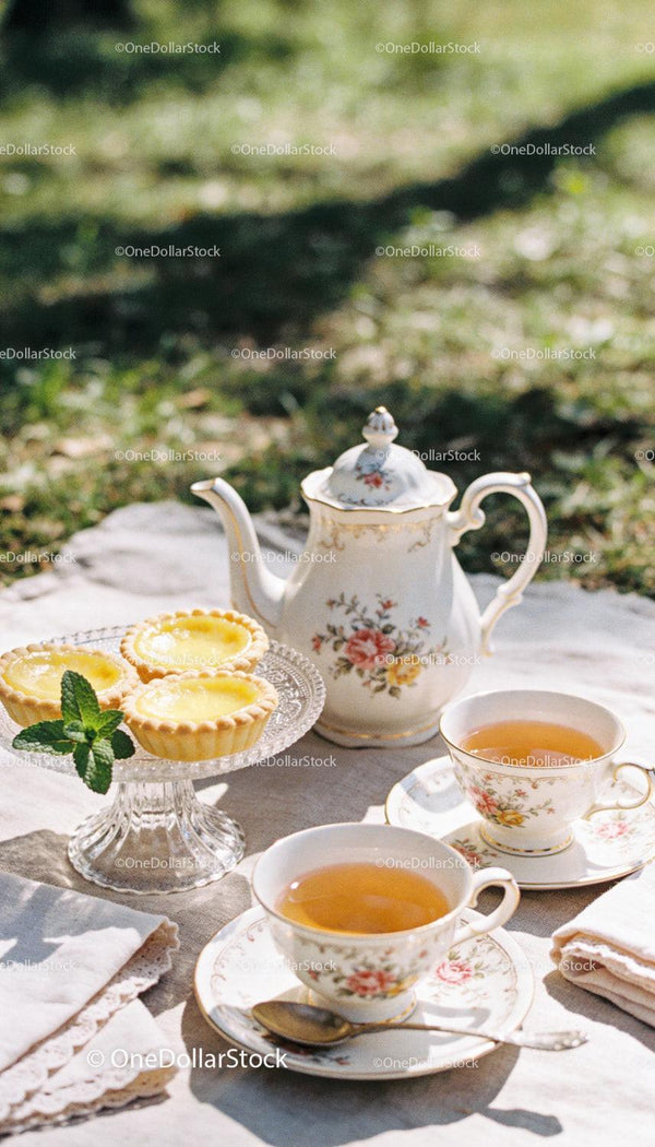 Elegant outdoor tea setting with lemon tarts