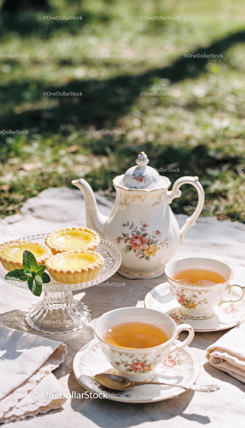 Elegant outdoor tea setting with lemon tarts
