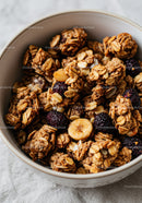 Crunchy granola clusters with dried fruits in bowl