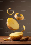 Fresh potato halves with peeling curls in motion