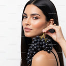 Elegant Woman with Black Hair Holding a Bunch of Grapes for Beauty Concept