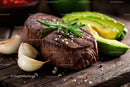 Juicy Steak with Fresh Avocado and Garlic on Rustic Wooden Board