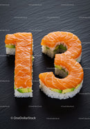 Sushi Rolls Shaped as Number Thirteen on Black Slate