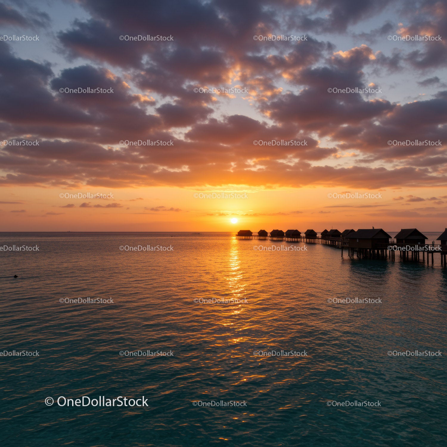 Beautiful Sunset over Overwater Bungalows in Tropical Paradise