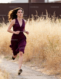 Woman Running Confidently Through Dry Grass Path