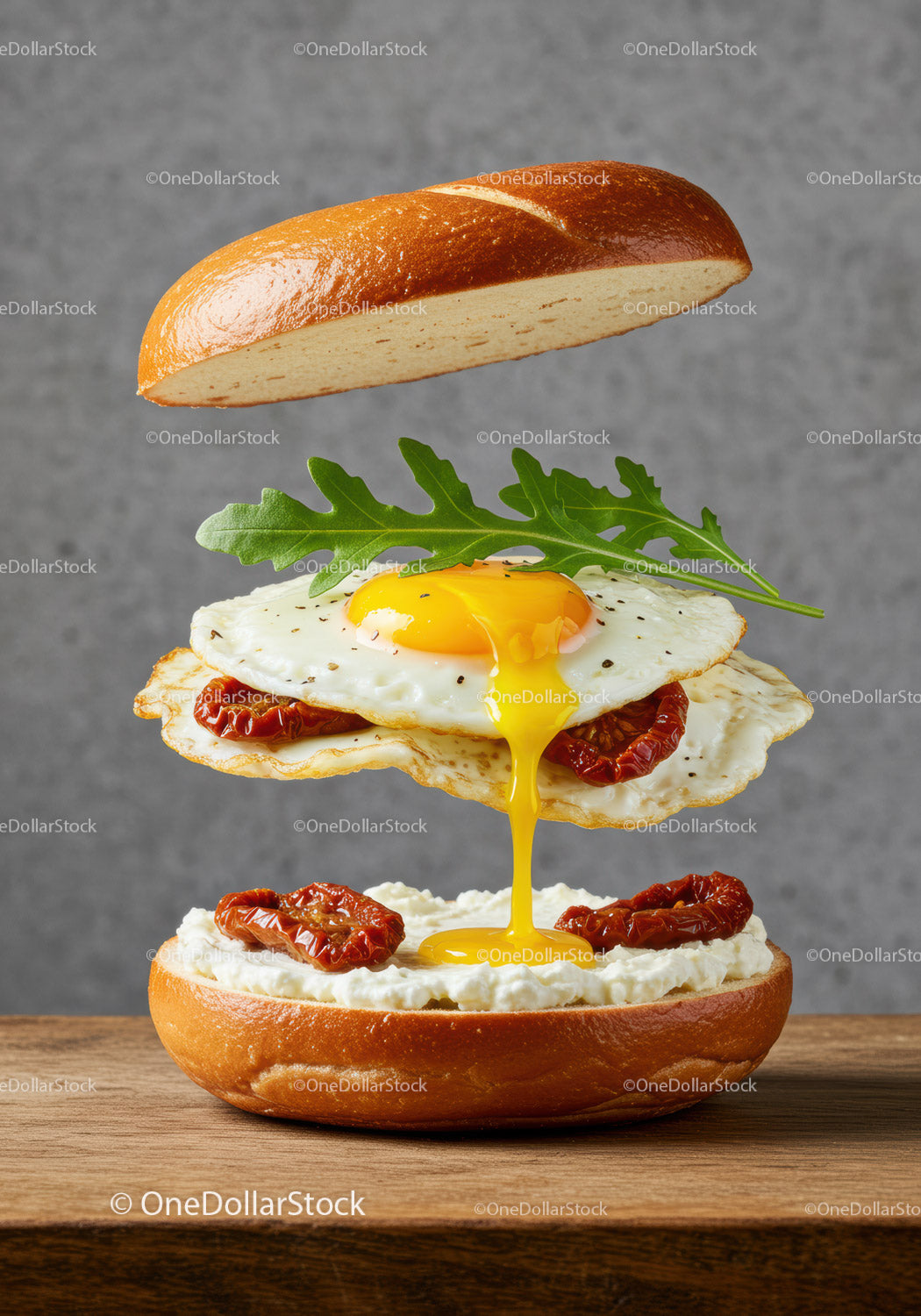 Fried egg sandwich with sun dried tomatoes and arugula