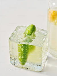 Fresh cucumber frozen inside a clear ice cube