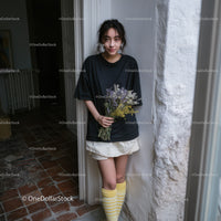 Casual Young Woman Holding Bouquet of Wildflowers Indoors