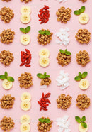 Healthy breakfast ingredients arranged on pink background