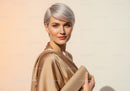 Elegant Portrait of a Woman with Short Silver Hair Wearing a Beige Silk Blouse