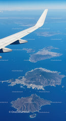 Aerial View of Islands and Ocean from Airplane Wing