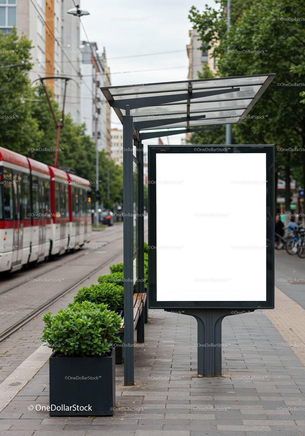 Urban tram stop with blank advertising board and greenery