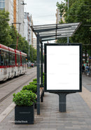 Urban tram stop with blank advertising board and greenery