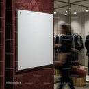 Empty White Sign on Textured Wall in Modern Clothing Store