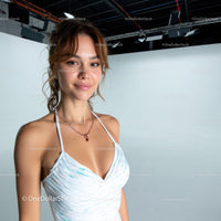 Young Woman Smiling in White Dress with Studio Background