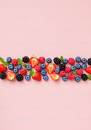 Fresh mixed berries with mint on pastel pink background