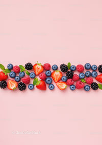 Fresh mixed berries with mint on pastel pink background