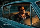 Stylish Man in Sunglasses Driving Classic Vintage Car at Sunset