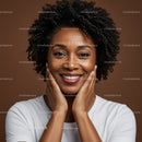 Portrait of a Smiling Black Woman with Curly Hair in Warm Studio Lighting