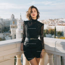 Elegant Black Lace Dress Woman Standing on Balcony with Cityscape View