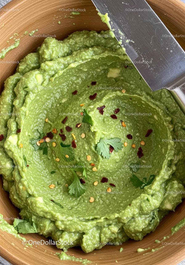 Creamy guacamole with fresh cilantro and chili flakes