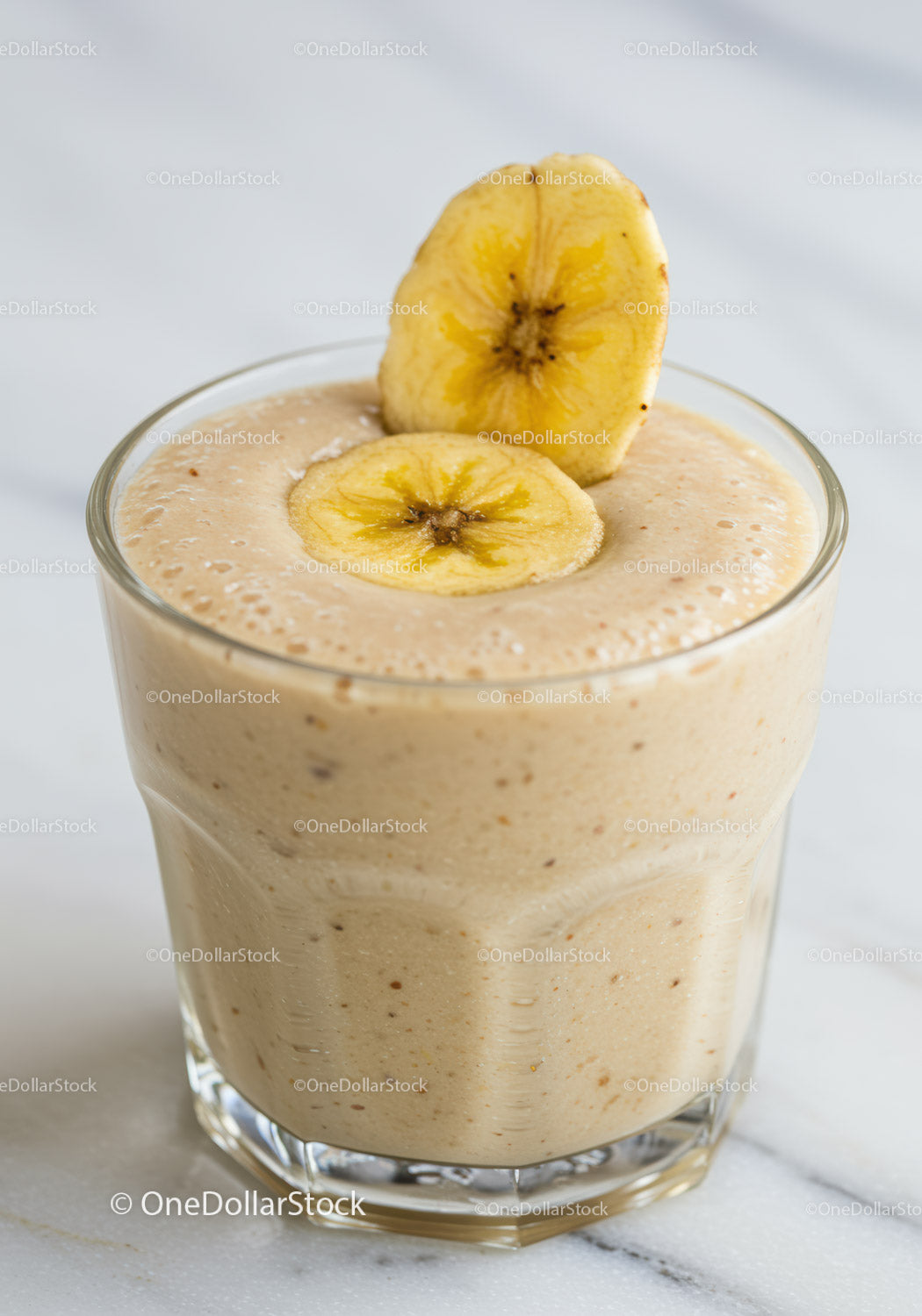 Creamy banana smoothie topped with dried banana chips