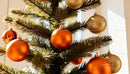 Decorated Christmas tree with orange and gold baubles