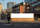 Cyclist passing blank billboard in urban city street JPG Mockup Image preview