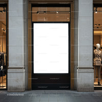 Empty illuminated billboard between fashion displays on street