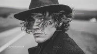 Young Man with Curly Hair and Styled Hat in Black and White Portrait