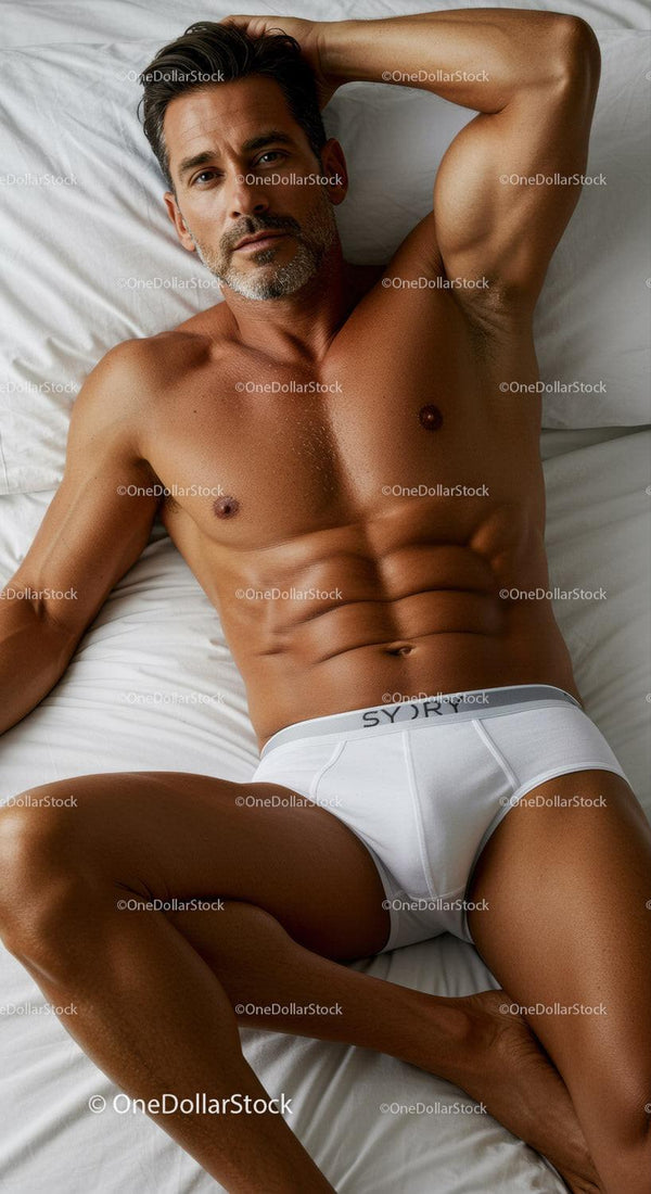 Fit mature man relaxing on bed in white underwear