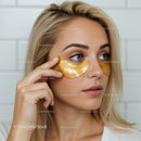 Young Woman Using Gold Under-Eye Patches for Skin Rejuvenation