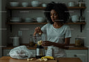 Woman Preparing Banana Smoothie in Modern Kitchen for Healthy Breakfast