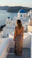 Woman enjoying view of Santorini blue domes at sunset