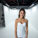 Smiling Young Woman in White Corset Dress in Studio Setting