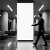 Blurred businessman walking past large blank urban billboard