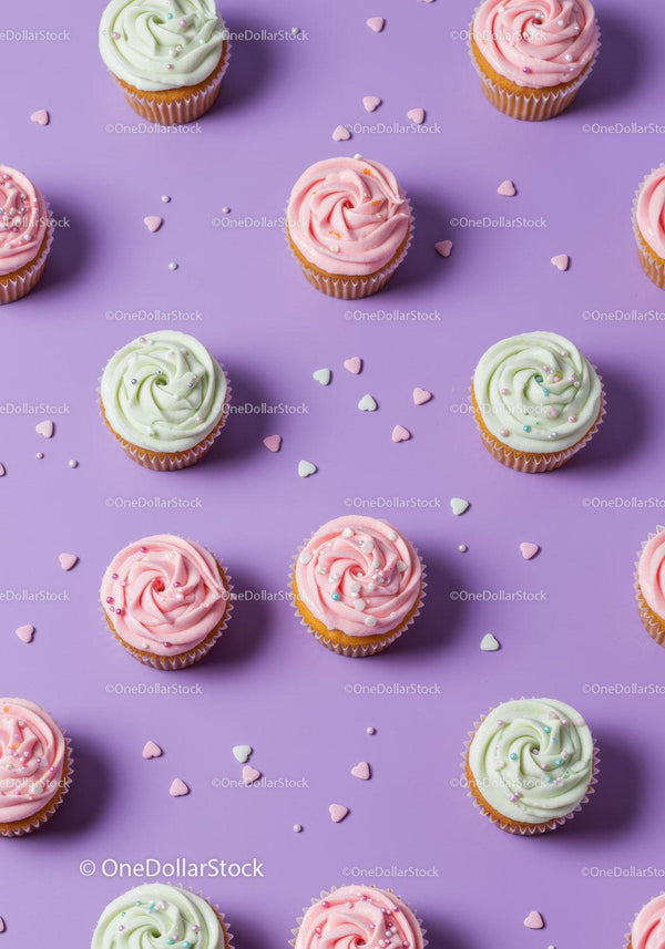 Colorful cupcakes with pastel frosting on purple background