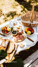Rustic Picnic Setup with Fresh Fruits and Artisan Bread