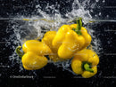 Vibrant Yellow Bell Peppers Splashing into Water
