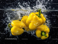 Vibrant Yellow Bell Peppers Splashing into Water